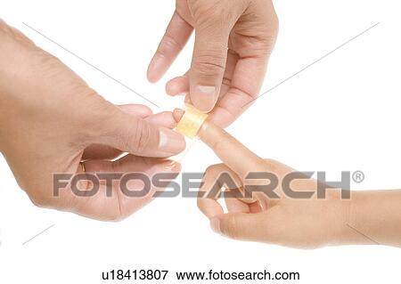 Stock Photo - Mother putting bandage on child. Fotosearch