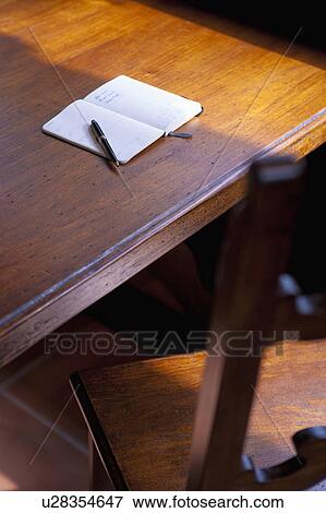 Stock Photo - Notebook and Pen on Wooden Table. Fotosearch