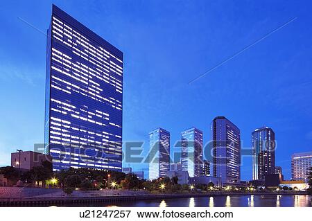 Stock Photo - Office buildings and river at night, Osaka Prefecture, Honshu, Japan. Fotosearch