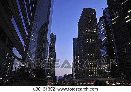 Stock Image - Office buildings at dusk, Shiodome, Minato Ward, Tokyo Prefecture, Honshu, Japan. Fotosearch