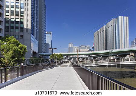 Stock Photo - Office buildings, Nakajima Garden bridge and Dojima river, Osaka Prefecture, Honshu, Japan. Fotosearch