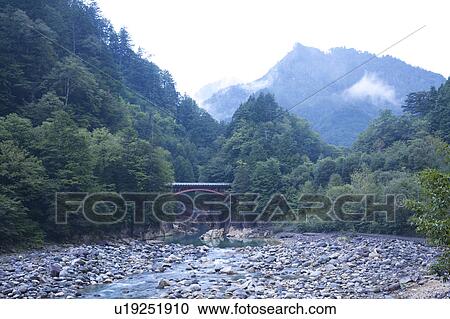 Stock Image - Otaki river and Ohshikabuchi bridge, Nagano Prefecture, Honshu, Japan . Fotosearch