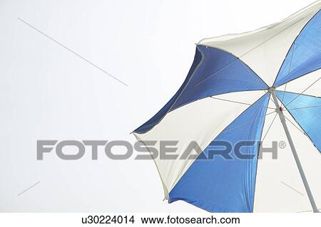 Parasol against sky, white background, copy space View Large Photo Image Picture - Parasol against sky, white background, copy space. Fotosearch