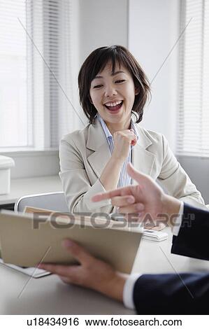 Person Showing Brochure to a Businesswoman View Large Photo Image Stock Photograph - Person Showing Brochure to a Businesswoman. Fotosearch