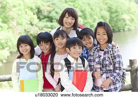 Portrait of school children and female teacher View Large Photo Image Stock Image - Portrait of school children and female teacher. Fotosearch