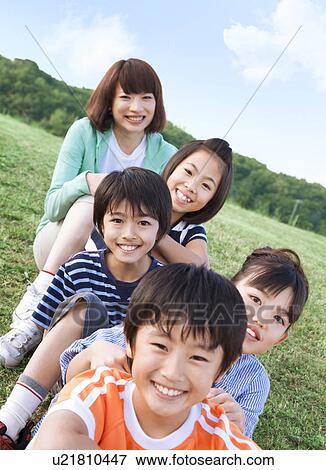 Portrait of school children and female teacher in field View Large Photo Image Stock Photo - Portrait of school children and female teacher in field. Fotosearch