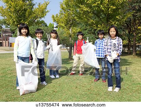 Picture - Portrait of school children holding bags for recycling. Fotosearch