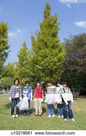 Portrait of school children holding bags for recycling View Large Photo Image Stock Image - Portrait of school children holding bags for recycling. Fotosearch