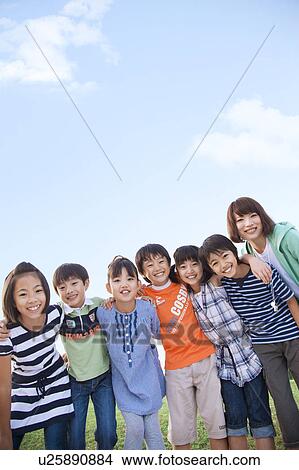 Picture - Portrait of school children with female teacher, copy space. Fotosearch