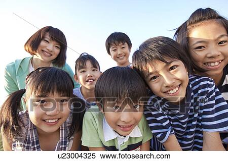 Portrait of school children with female teacher, smiling View Large Photo Image Stock Photography - Portrait of school children with female teacher, smiling. Fotosearch