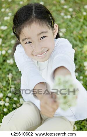 Stock Image - Portrait of Young Girl With Bunch of Flowers. Fotosearch