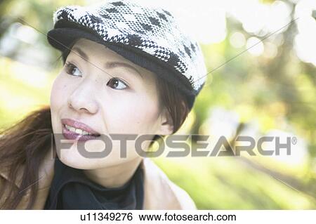 Stock Photograph - Portrait of Young Woman Outdoors. Fotosearch