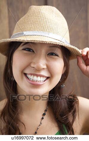 Portrait of young woman, smiling View Large Photo Image Stock Image - Portrait of young woman, smiling. Fotosearch