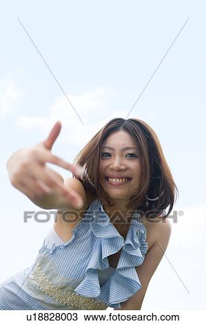 Stock Image - Portrait of young woman, smiling. Fotosearch