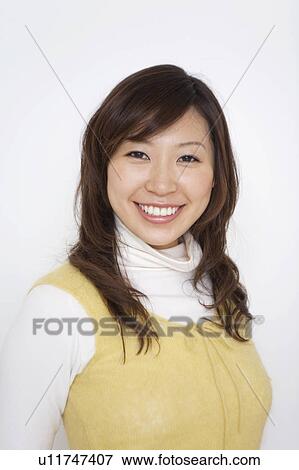 Portrait of young woman, smiling, white background View Large Photo Image Stock Photo - Portrait of young woman, smiling, white background. Fotosearch