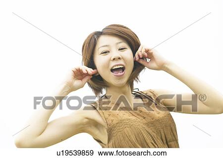 Portrait of young woman smiling, white background View Large Photo Image Stock Photo - Portrait of young woman smiling, white background. Fotosearch