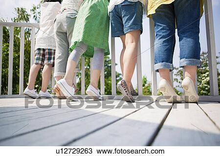 Rear View of Five Friends Leaning on Railing, Low Section View Large Photo Image Stock Image - Rear View of Five Friends Leaning on Railing, Low Section. Fotosearch