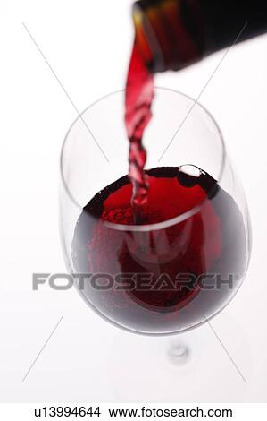 Red wine being poured into wineglass View Large Photo Image Picture - Red wine being poured into wineglass. Fotosearch