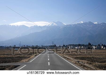 Stock Photo - Road in rice fields, Nagano Prefecture, Honshu, Japan. Fotosearch