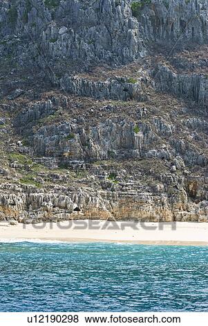 Stock Photo - Rocky Cliffs Near Beach. Fotosearch