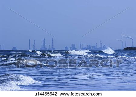 Stock Image - Rough Sea Near Industrial District. Fotosearch