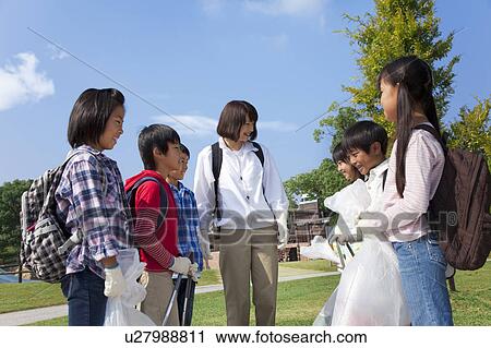 School children and female teacher holding bags for recycling View Large Photo Image Stock Image - School children and female teacher holding bags for recycling. Fotosearch