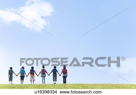 School children at riverbank, standing side by side, copy space View Large Photo Image Picture - School children at riverbank, standing side by side, copy space. Fotosearch