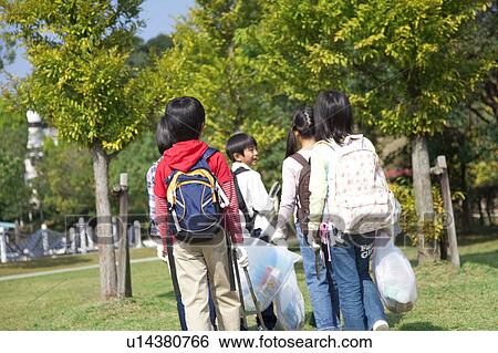 Stock Photograph - School children carrying bags for recycling. Fotosearch