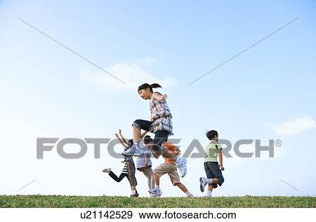 School children jumping at riverbank, copy space View Large Photo Image Stock Photo - School children jumping at riverbank, copy space. Fotosearch