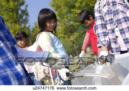 School children picking garbage in park View Large Photo Image Stock Photograph - School children picking garbage in park. Fotosearch