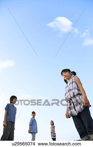 School children standing under sky, copy space View Large Photo Image Picture - School children standing under sky, copy space. Fotosearch