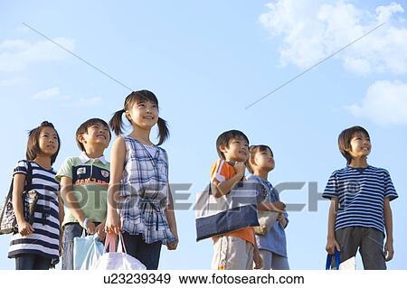 School children standing under sky, looking away, copy space View Large Photo Image Stock Photo - School children standing under sky, looking away, copy space. Fotosearch