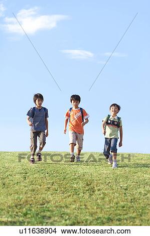 Schoolboys walking at riverbank, copy space View Large Photo Image Picture - Schoolboys walking at riverbank, copy space. Fotosearch