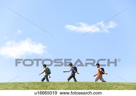 Schoolboys walking at riverbank, copy space View Large Photo Image Stock Photo - Schoolboys walking at riverbank, copy space. Fotosearch