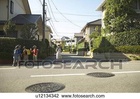 Schoolboys walking the street View Large Photo Image Stock Image - Schoolboys walking the street. Fotosearch