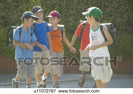 Schoolboys walking the street View Large Photo Image Stock Photo - Schoolboys walking the street. Fotosearch