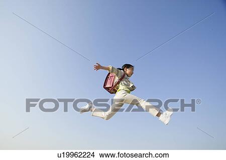 Picture - Schoolgirl Leaping Across Sky. Fotosearch