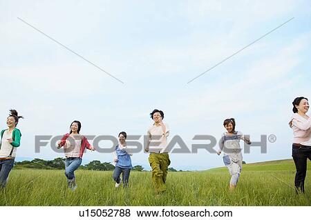 Seven Young Men and Women Running in Field View Large Photo Image Stock Photo - Seven Young Men and Women Running in Field. Fotosearch