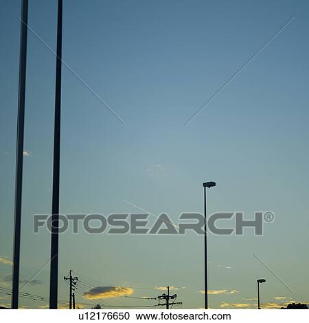 Stock Image - Silhouetted Lampposts Against Evening Sky. Fotosearch
