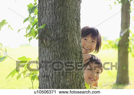 Sister and Brother Hiding Behind Tree View Large Photo Image Stock Image - Sister and Brother Hiding Behind Tree. Fotosearch