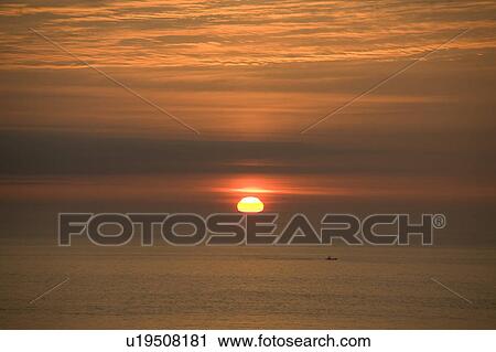 Stock Image - Sunrise Over the Sea. Fotosearch