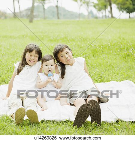 Three Sisters Sitting on Blanket Outdoors View Large Photo Image Stock Photograph - Three Sisters Sitting on Blanket Outdoors. Fotosearch