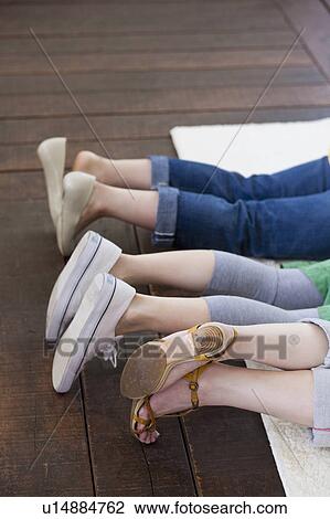Three Women Lying on Rug, Focus on Legs View Large Photo Image Stock Image - Three Women Lying on Rug, Focus on Legs. Fotosearch