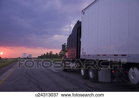 Trucks on highway at dusk, Iowa, USA View Large Photo Image Stock Photo - Trucks on highway at dusk, Iowa, USA. Fotosearch