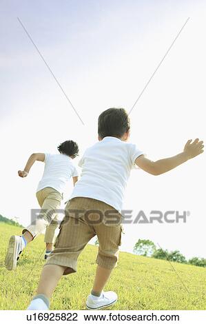 Stock Image - Two Children Running in Field. Fotosearch