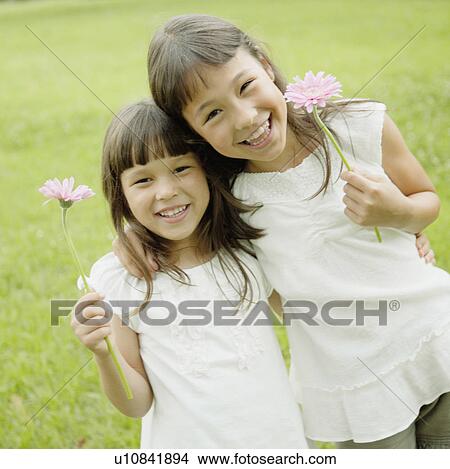 Two Girls Holding Flowers View Large Photo Image Picture - Two Girls Holding Flowers. Fotosearch