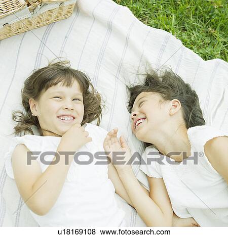 Two Girls Lying on Picnic Towel View Large Photo Image Stock Photo - Two Girls Lying on Picnic Towel. Fotosearch