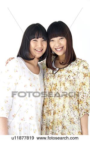 Two Young Women Cuddling, Holding Shoulders View Large Photo Image Stock Photo - Two Young Women Cuddling, Holding Shoulders. Fotosearch