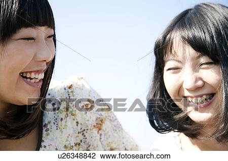 Stock Image - Two Young Women Smiling. Fotosearch