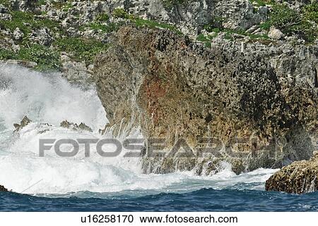 Stock Image - Water Splashing Against Rocks. Fotosearch